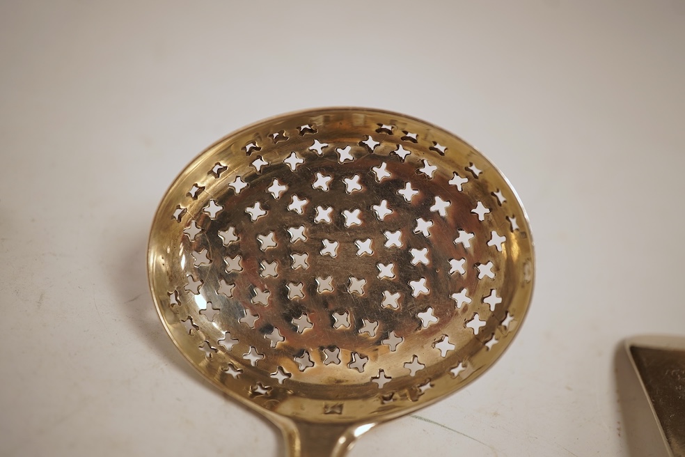 A George III silver fiddle pattern stilton scoop, John Lias, London, 1816, 20cm, together with two Georgian silver sauce ladles, a similar sifter ladle and a William IV shell pattern fish knife, 8.9oz.